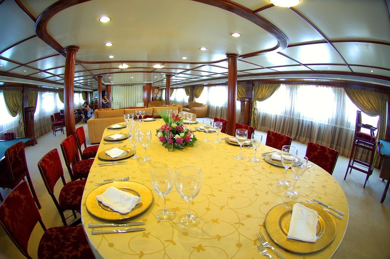 a large table with plates and glasses aboard BLUE DAWN Yacht for Sale