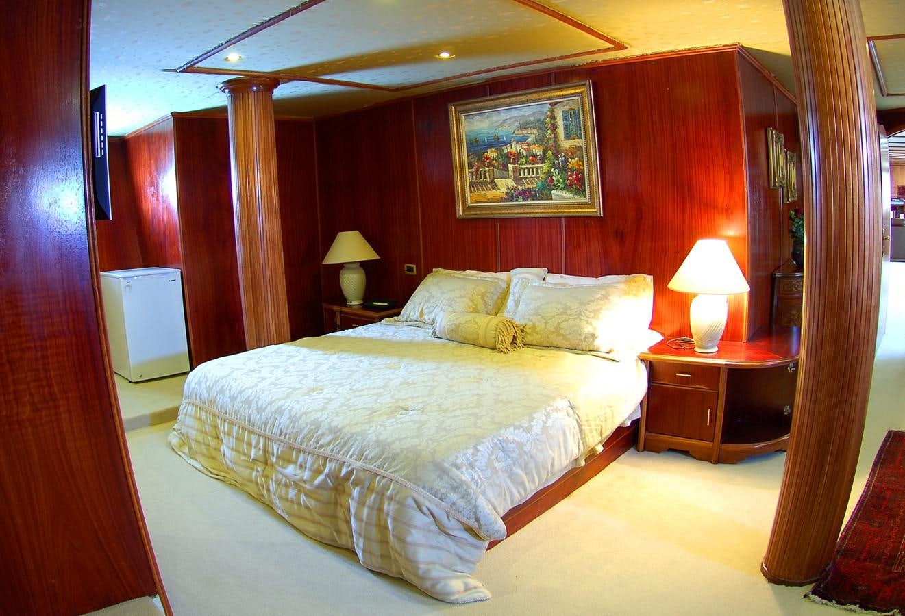 a bed with a lamp on it aboard BLUE DAWN Yacht for Sale