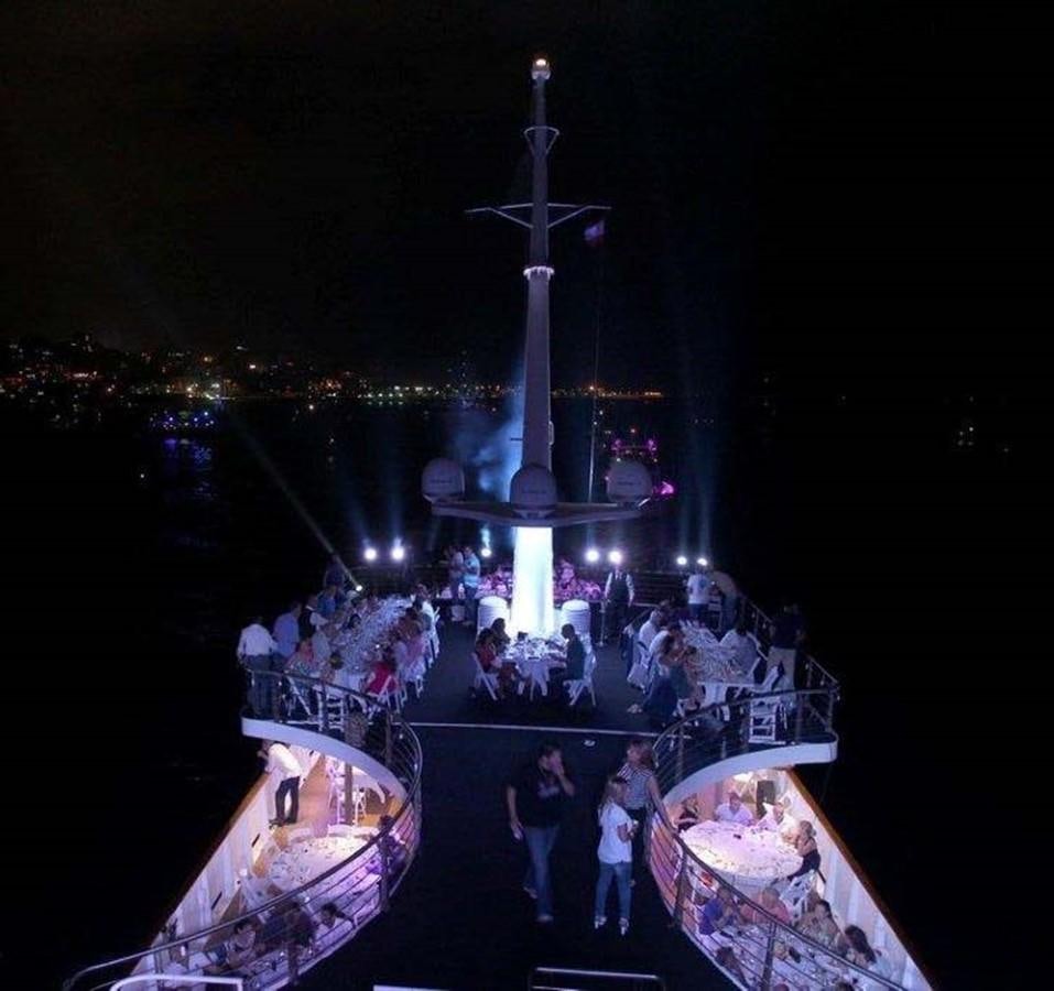 a group of people on a boat at night aboard BLUE DAWN Yacht for Sale