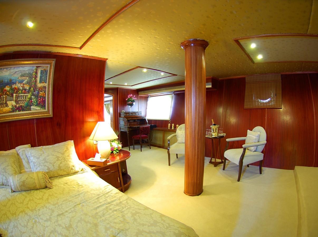 a hotel room with a bed and desk aboard BLUE DAWN Yacht for Sale