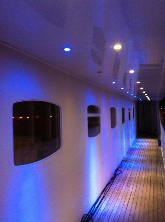 a hallway with a window and a door with a window aboard BLUE DAWN Yacht for Sale