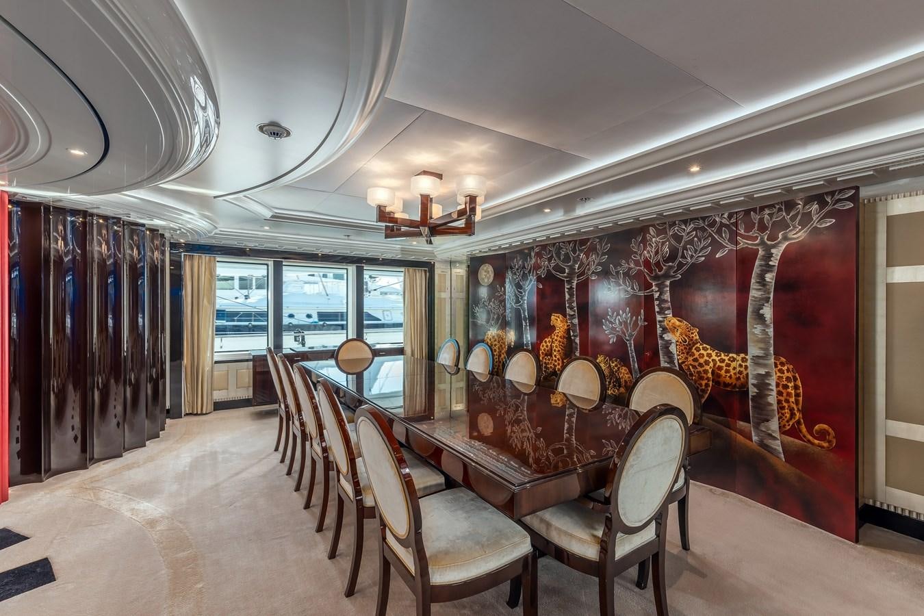 a dining room with a large painting aboard MARGUERITE Yacht for Sale