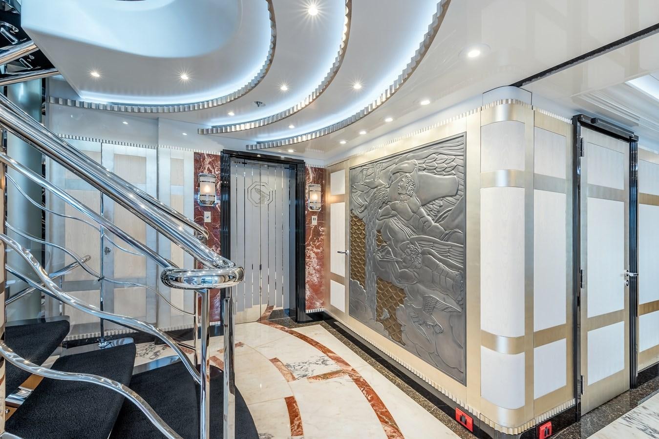 a room with a staircase and a painting on the wall aboard MARGUERITE Yacht for Sale