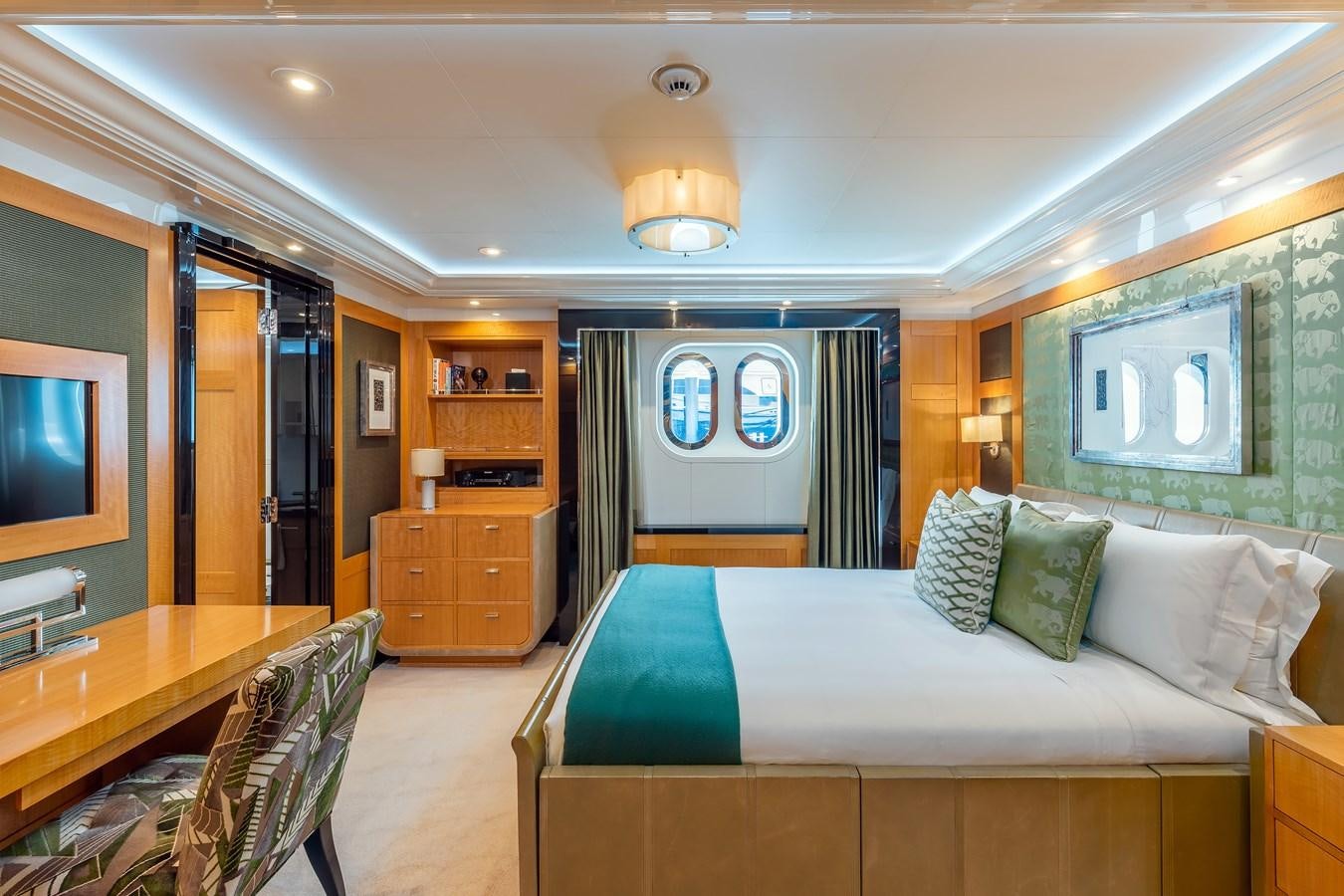 a bedroom with a bed and a desk aboard MARGUERITE Yacht for Sale