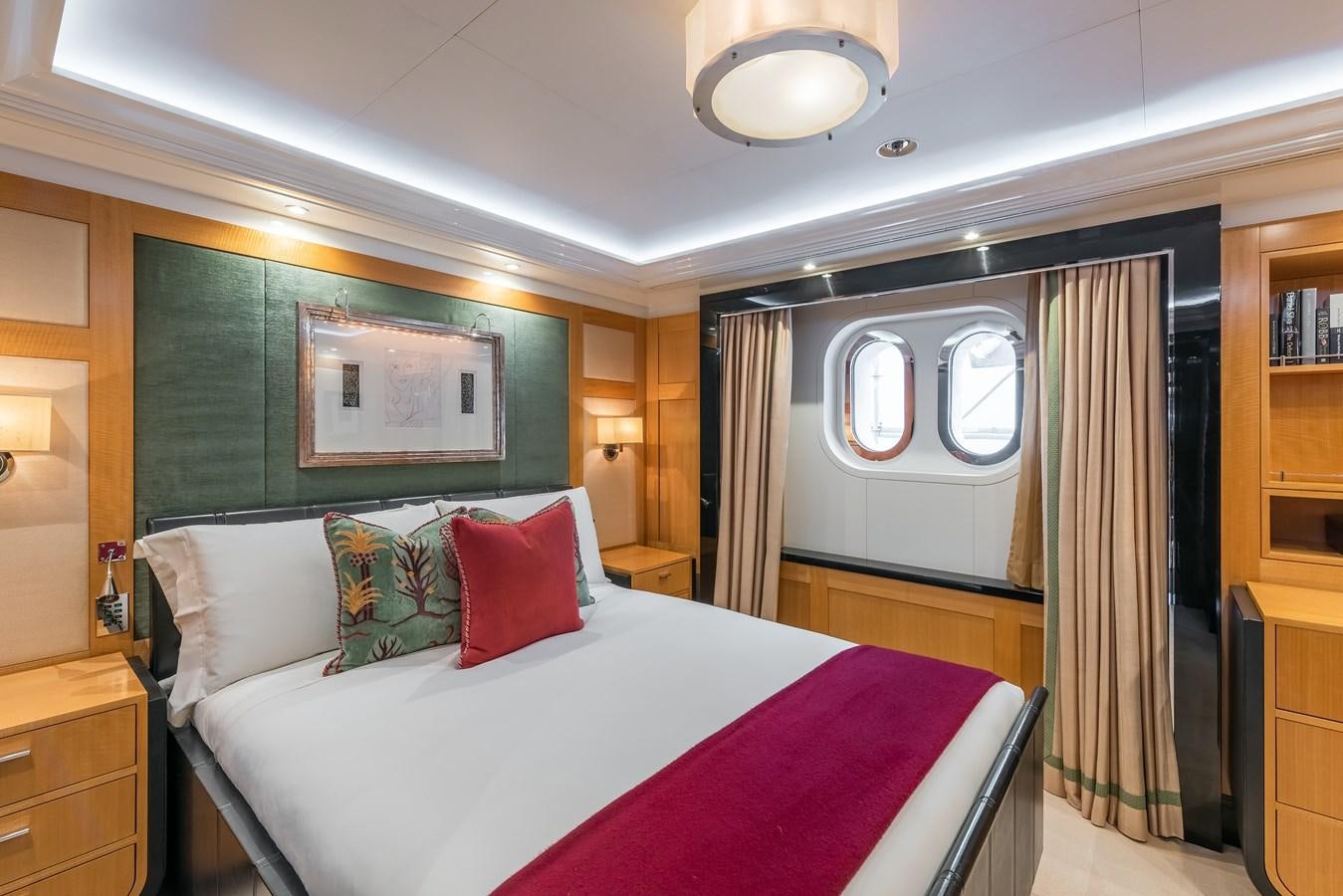 a bedroom with a bed and a mirror aboard MARGUERITE Yacht for Sale