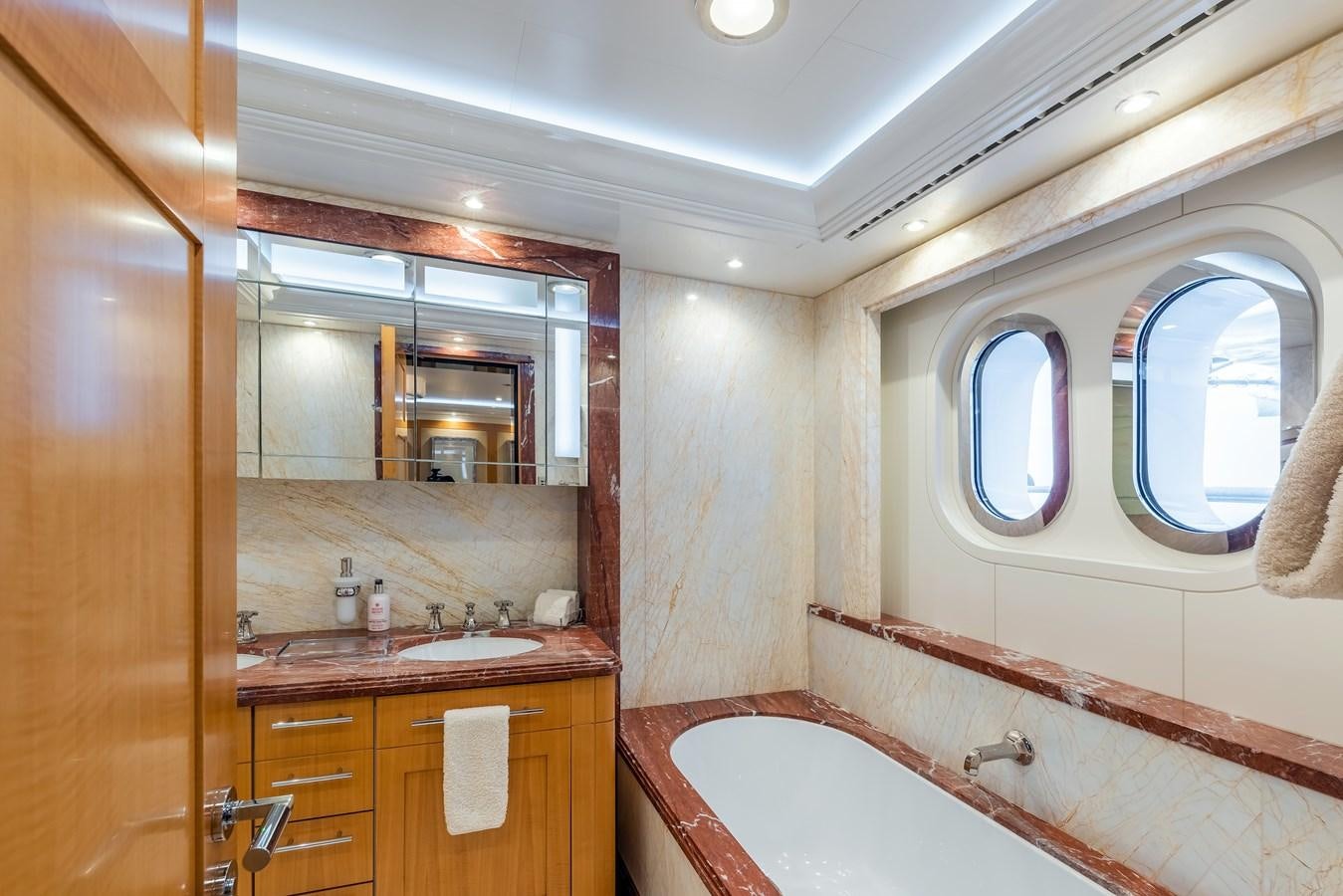 a bathroom with a tub sink and a mirror aboard MARGUERITE Yacht for Sale