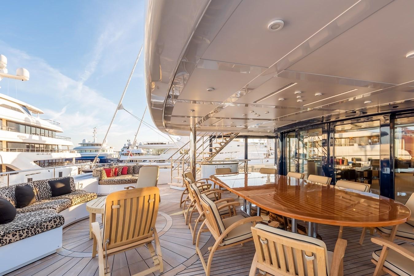 a deck with a table and chairs aboard MARGUERITE Yacht for Sale