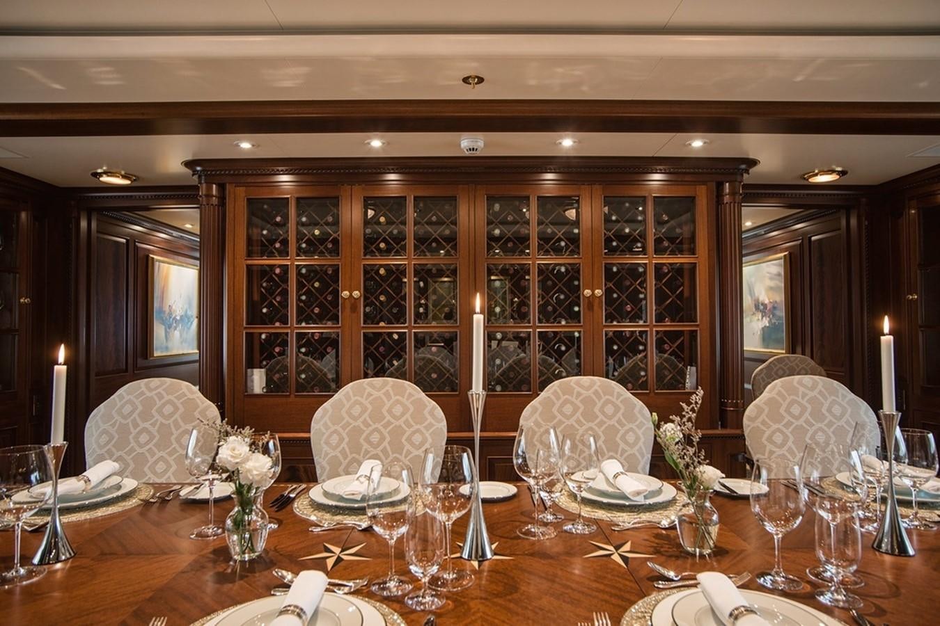 a dining room table with plates and chairs aboard PARAFFIN Yacht for Sale