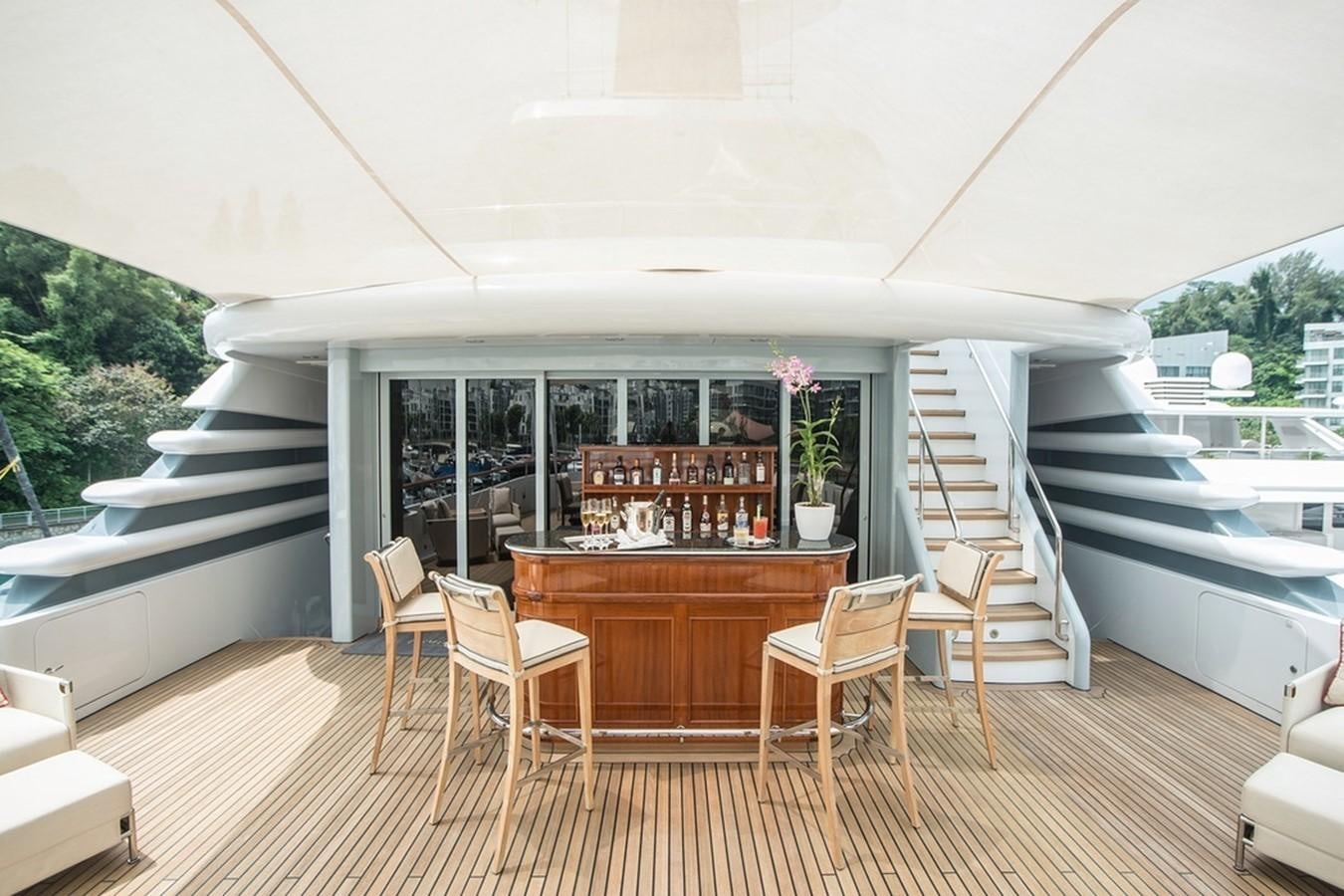 a large open house with a wooden deck and a large pool aboard PARAFFIN Yacht for Sale