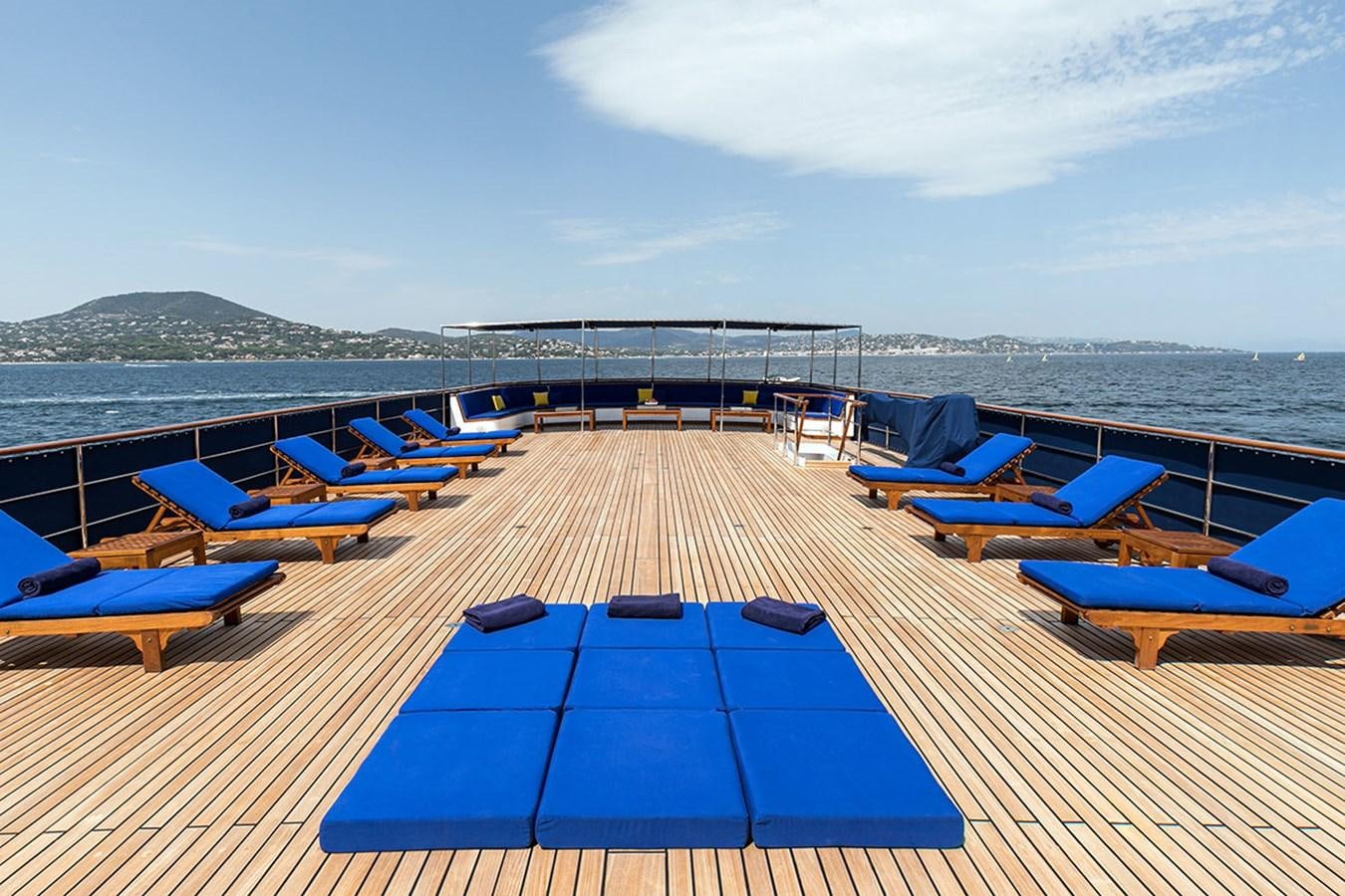 a deck with lounge chairs on it aboard PALOMA Yacht for Sale
