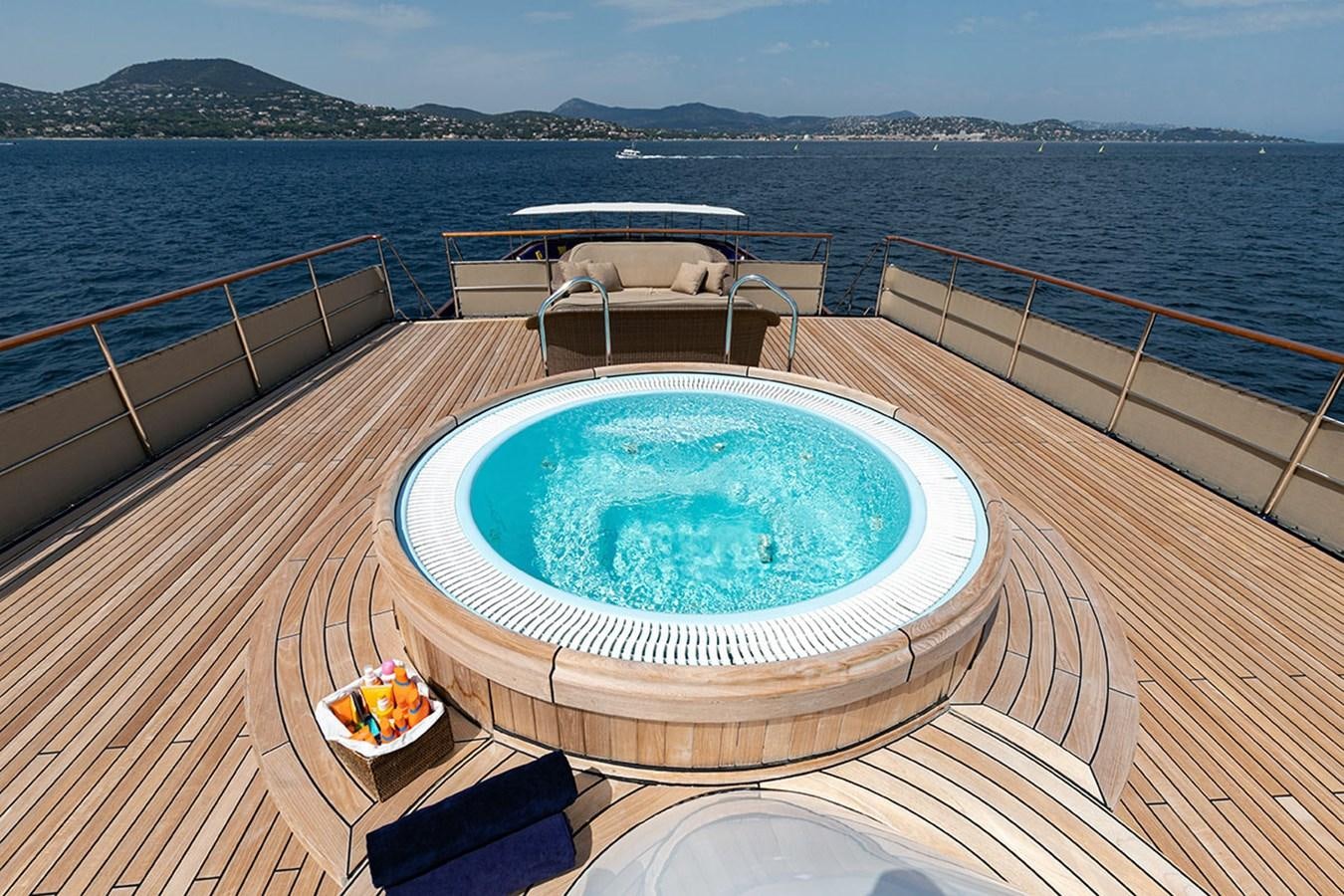 a pool on a deck overlooking a body of water aboard PALOMA Yacht for Sale