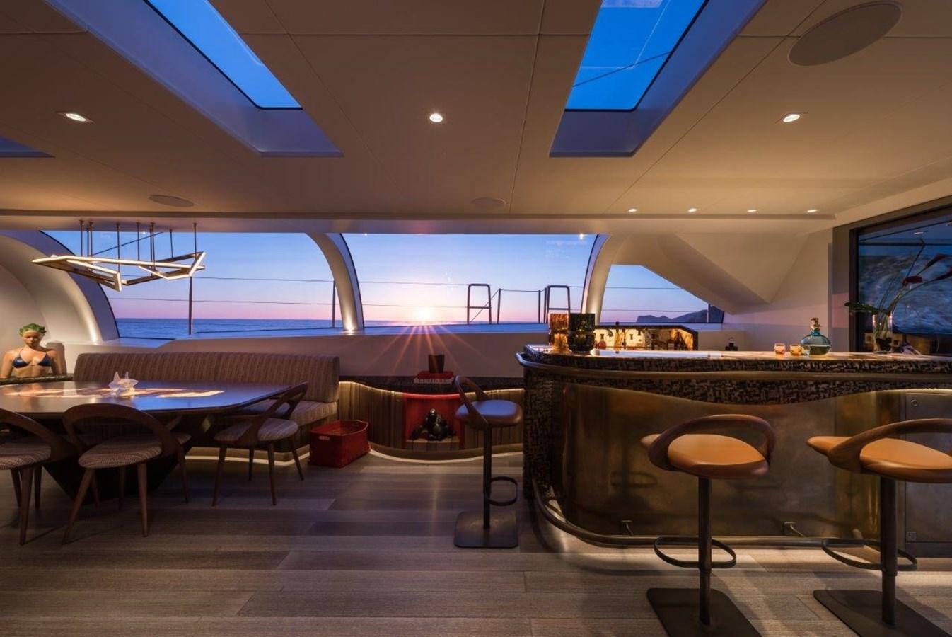 a room with tables and chairs aboard NGONI Yacht for Sale