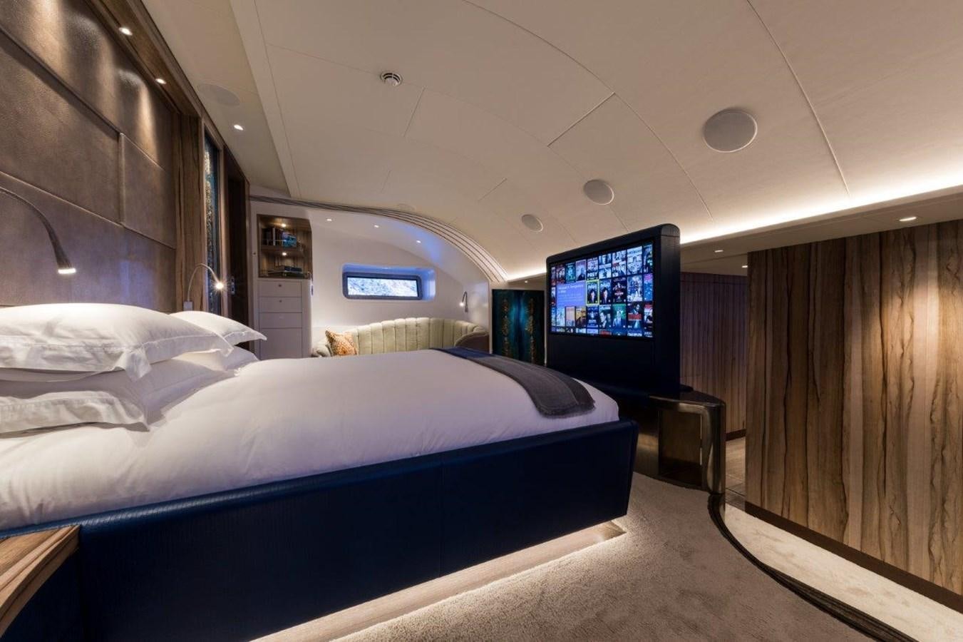 a room with a bed and a television aboard NGONI Yacht for Sale