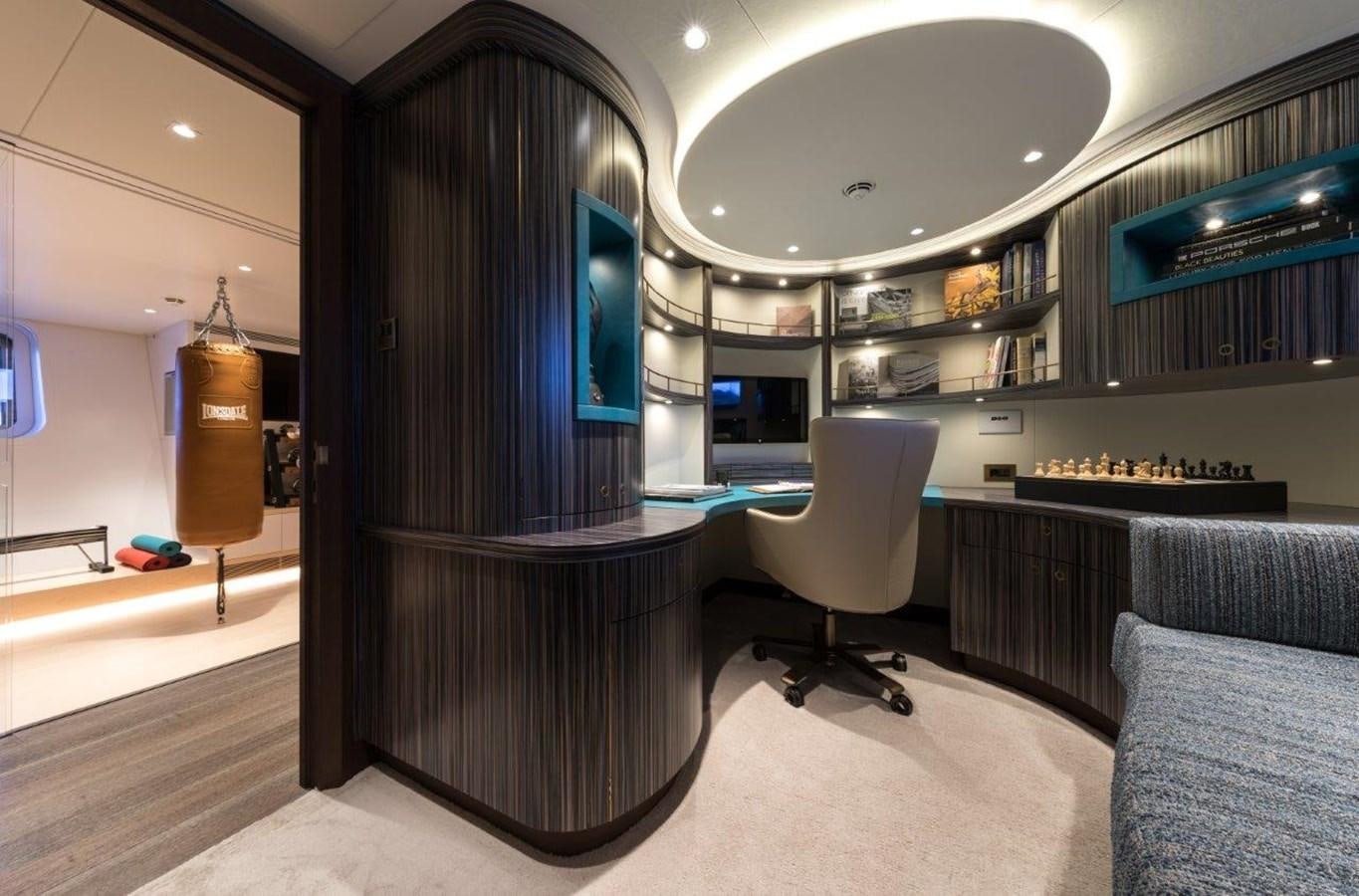 a room with a black wall and a black table and chairs aboard NGONI Yacht for Sale