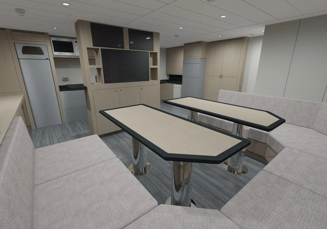 a room with a table and couch aboard PROJECT 561 Yacht for Sale