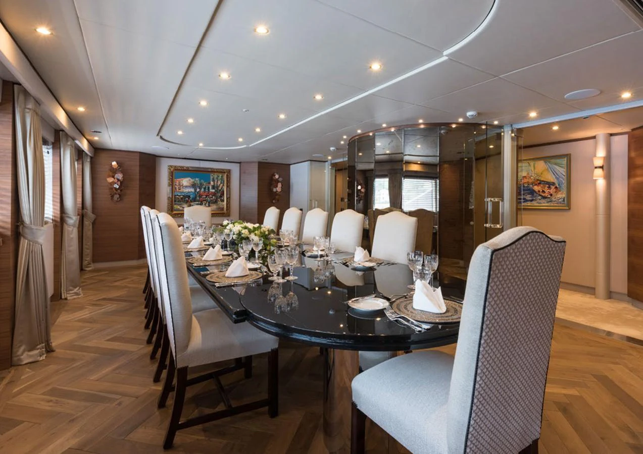 a dining room with a table and chairs aboard LADY A Yacht for Sale