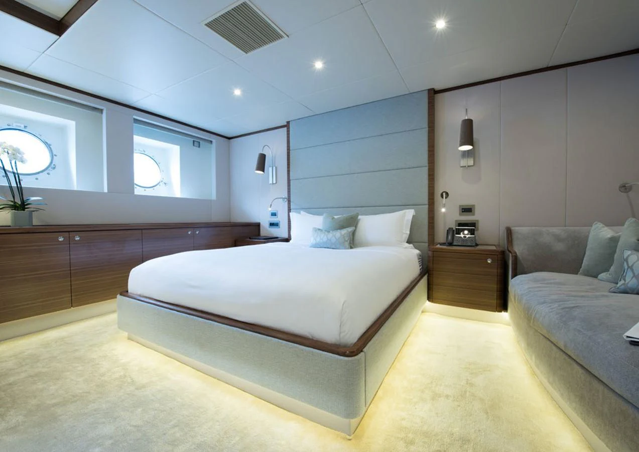 a bedroom with a bed and a couch aboard LADY A Yacht for Sale