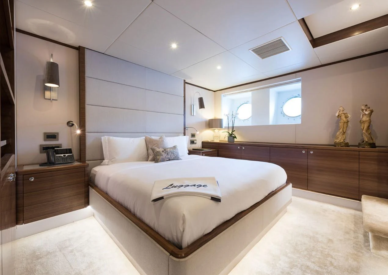 a modern bedroom with a large bed aboard LADY A Yacht for Sale