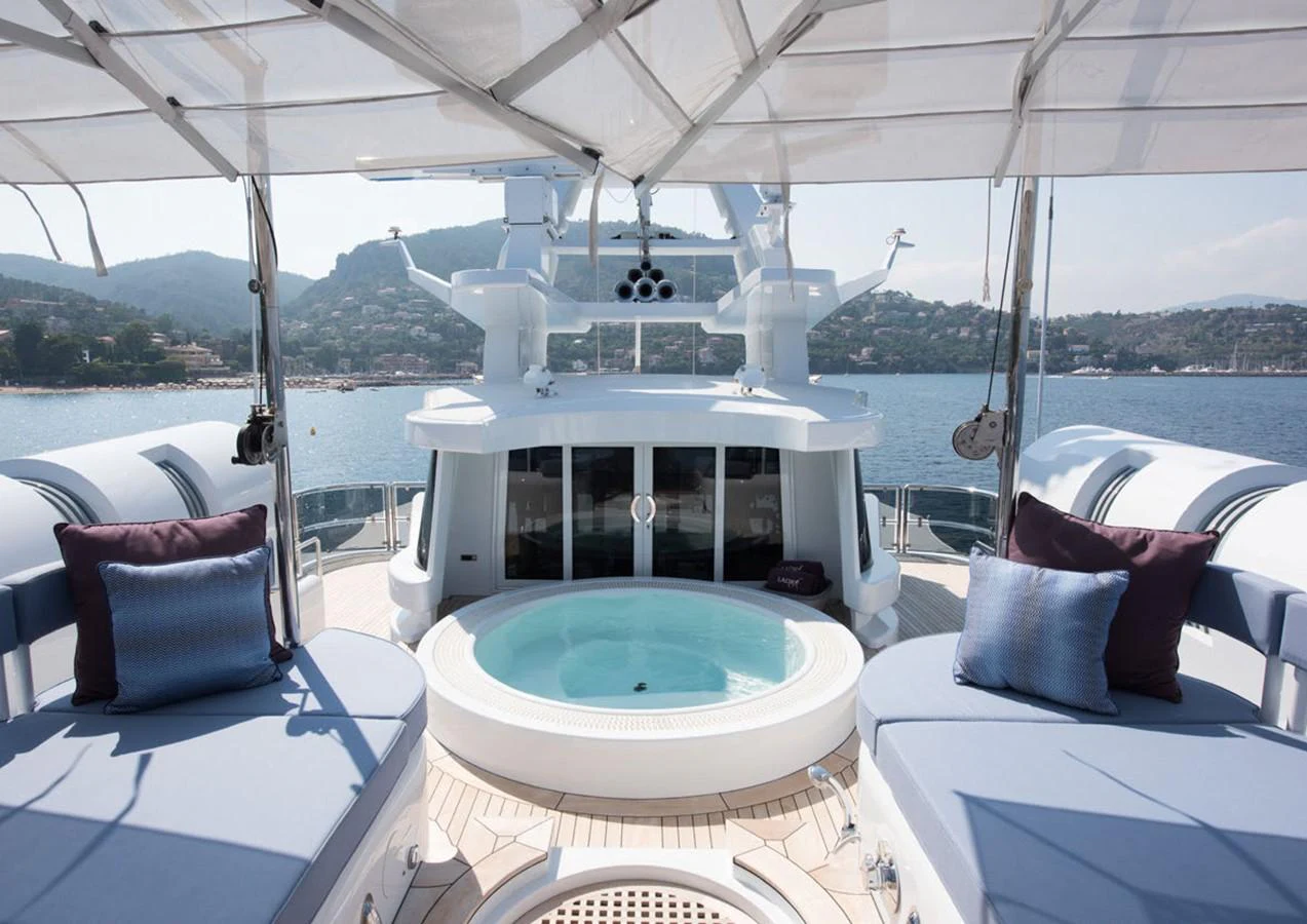 a boat with a large white table and chairs on a boat aboard LADY A Yacht for Sale