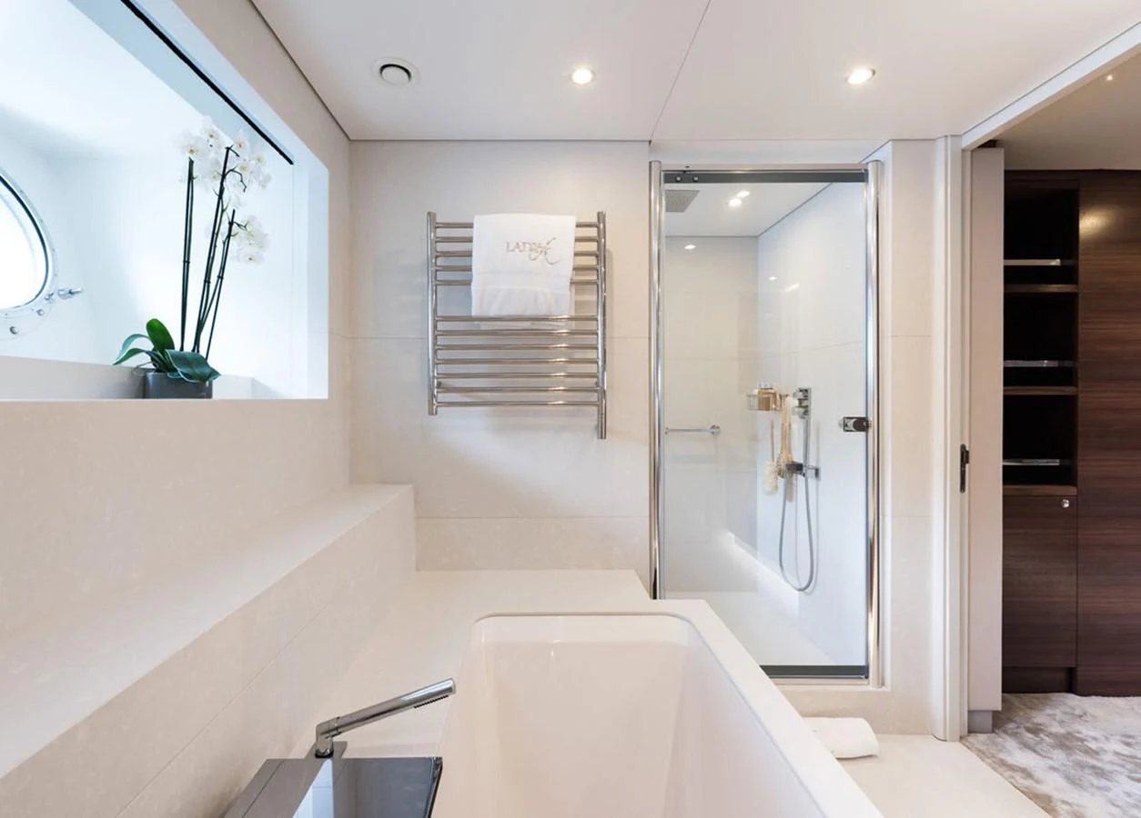 a bathroom with a bathtub and shower aboard LADY A Yacht for Sale