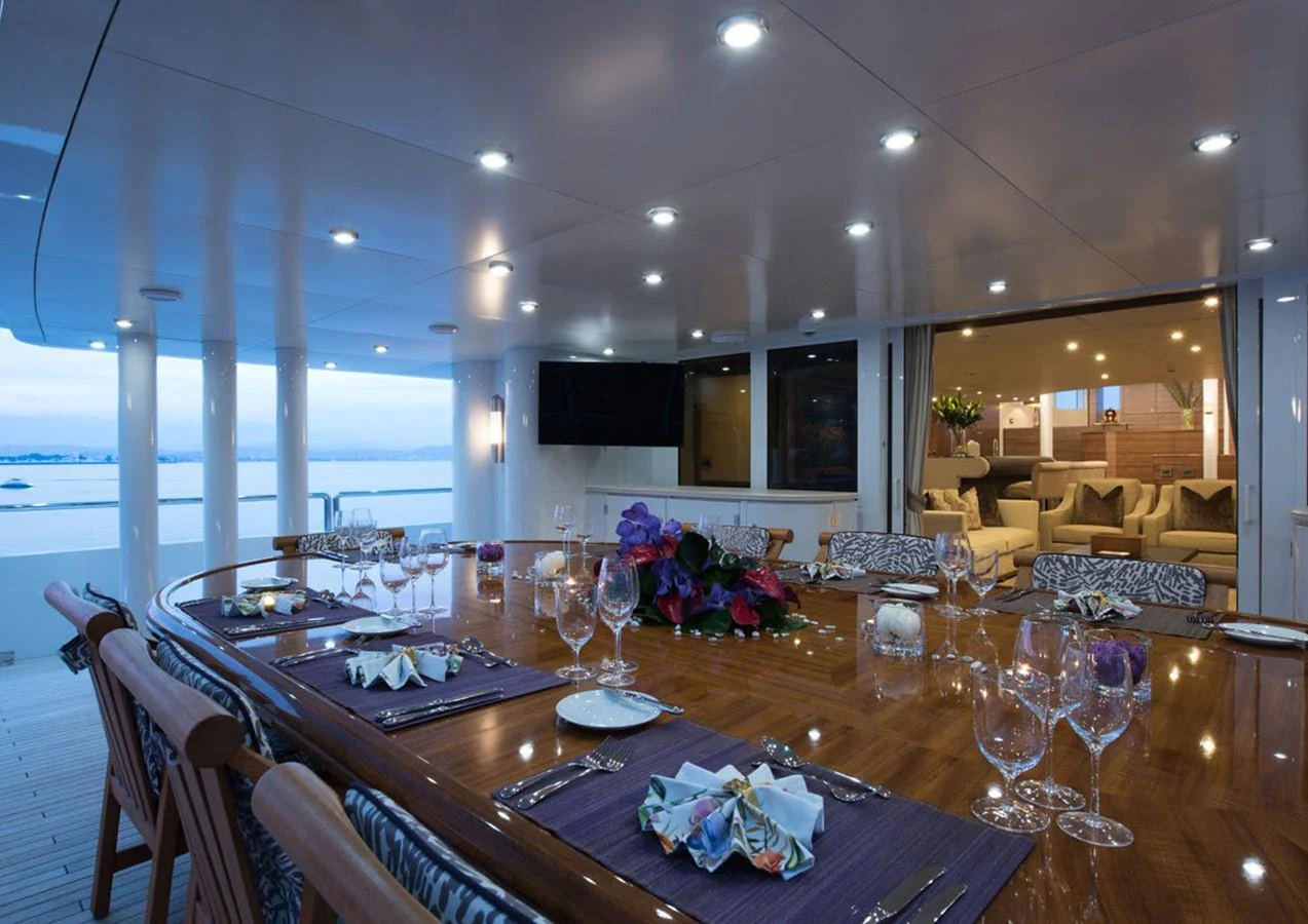 a dining table with a view of the water aboard LADY A Yacht for Sale