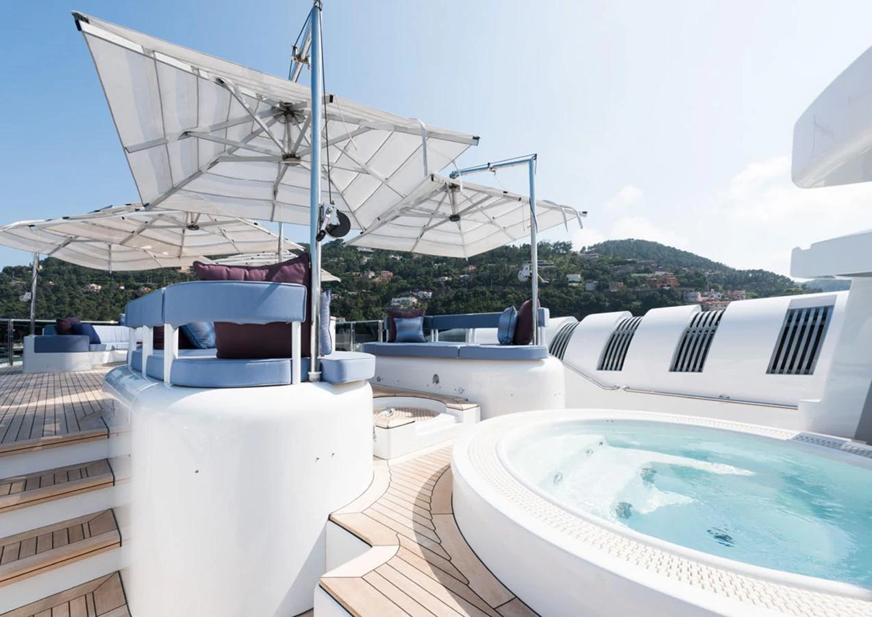 a large white boat with a canopy aboard LADY A Yacht for Sale