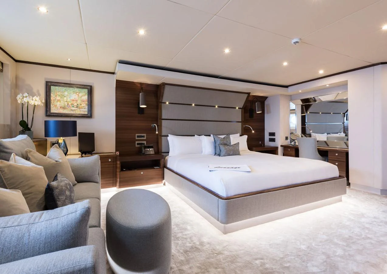 a bedroom with a bed and a couch aboard LADY A Yacht for Sale