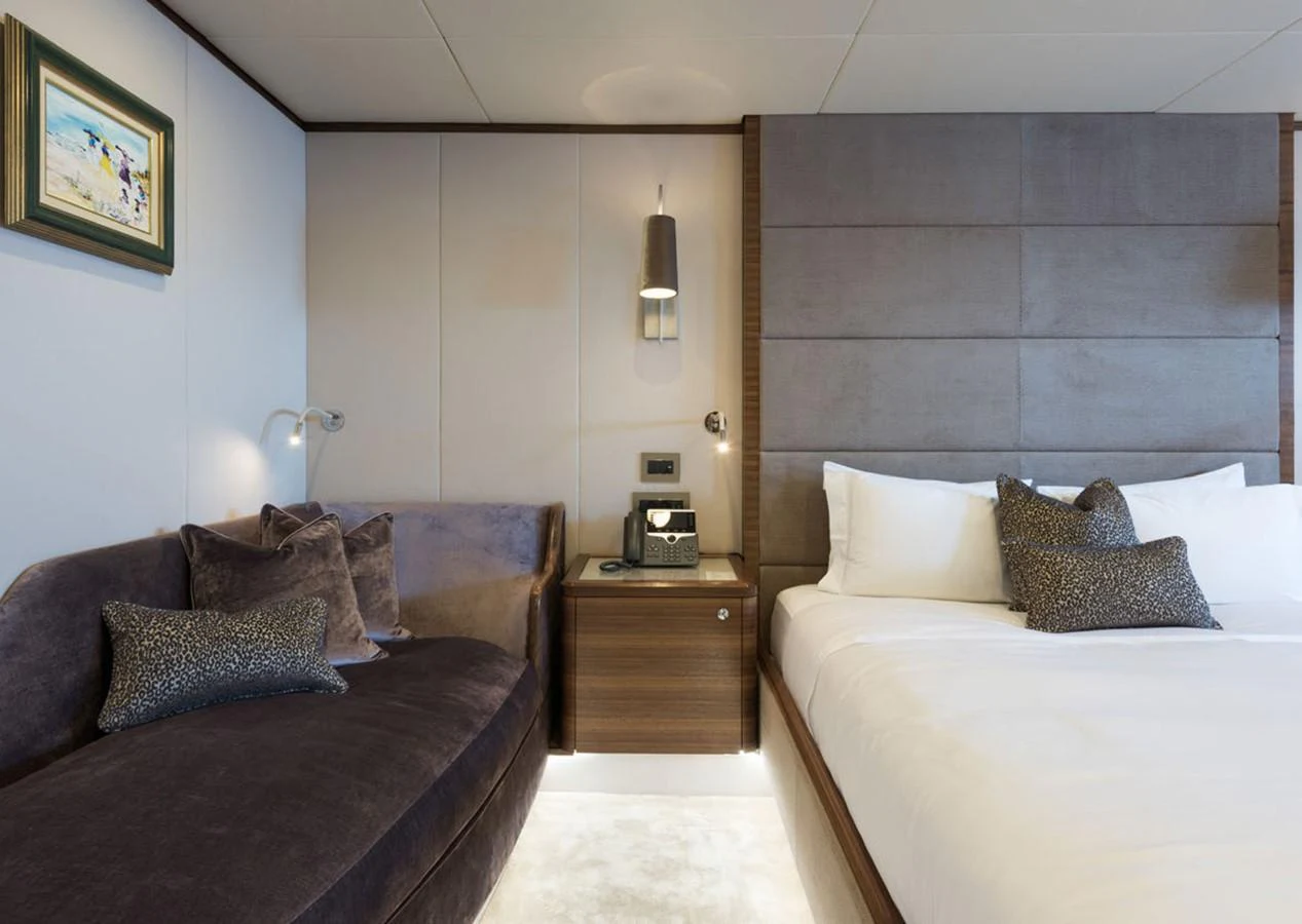 a room with a bed and a couch aboard LADY A Yacht for Sale
