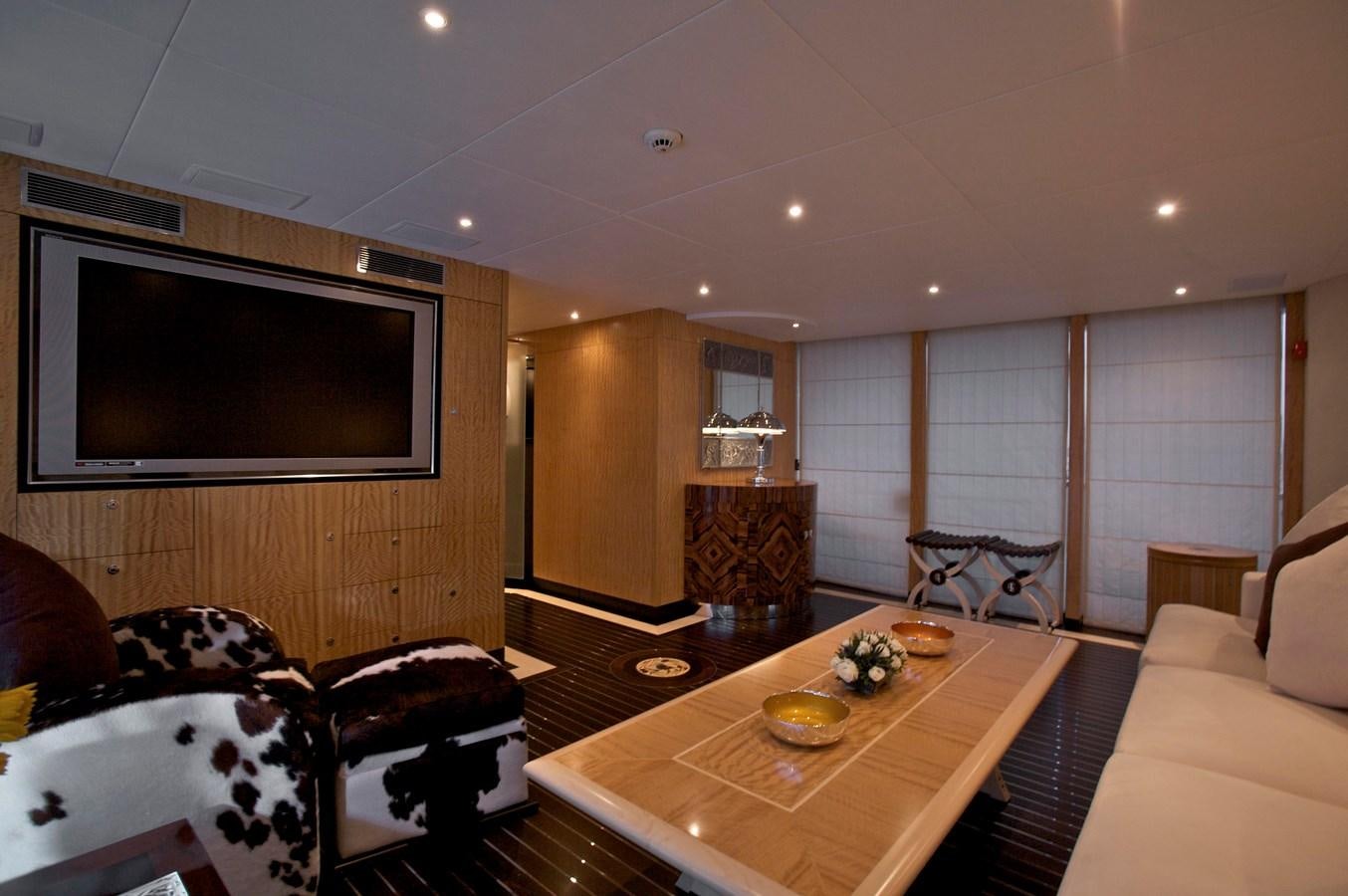 a living room with a tv and furniture aboard ACHILLES Yacht for Sale