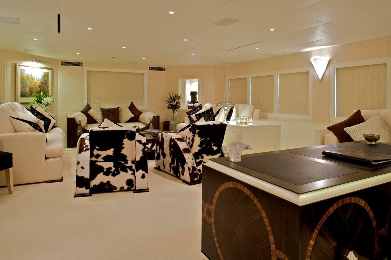 a large living room with a large table and chairs aboard ACHILLES Yacht for Sale