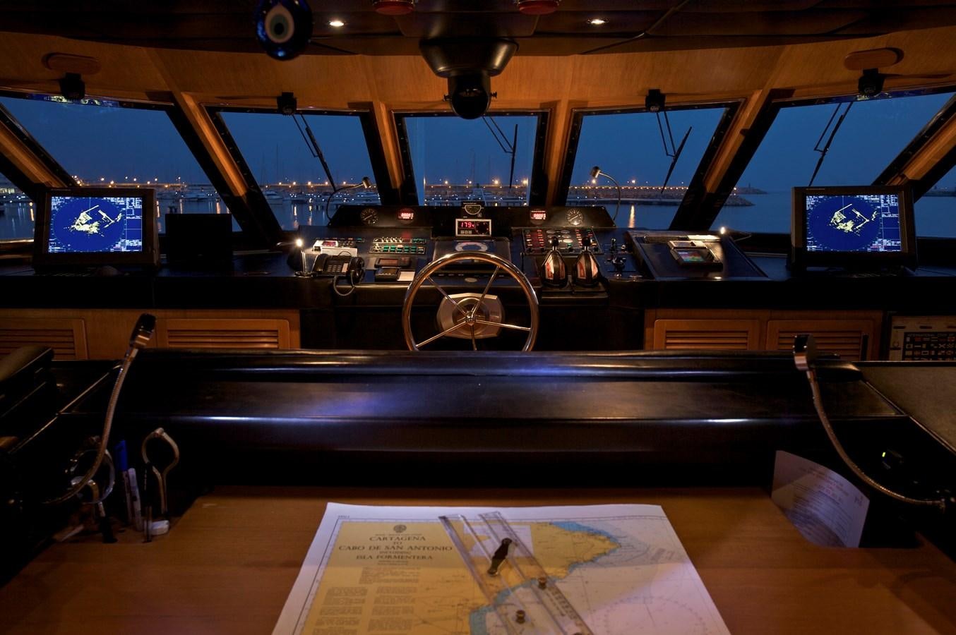 a room with a table and tv aboard ACHILLES Yacht for Sale