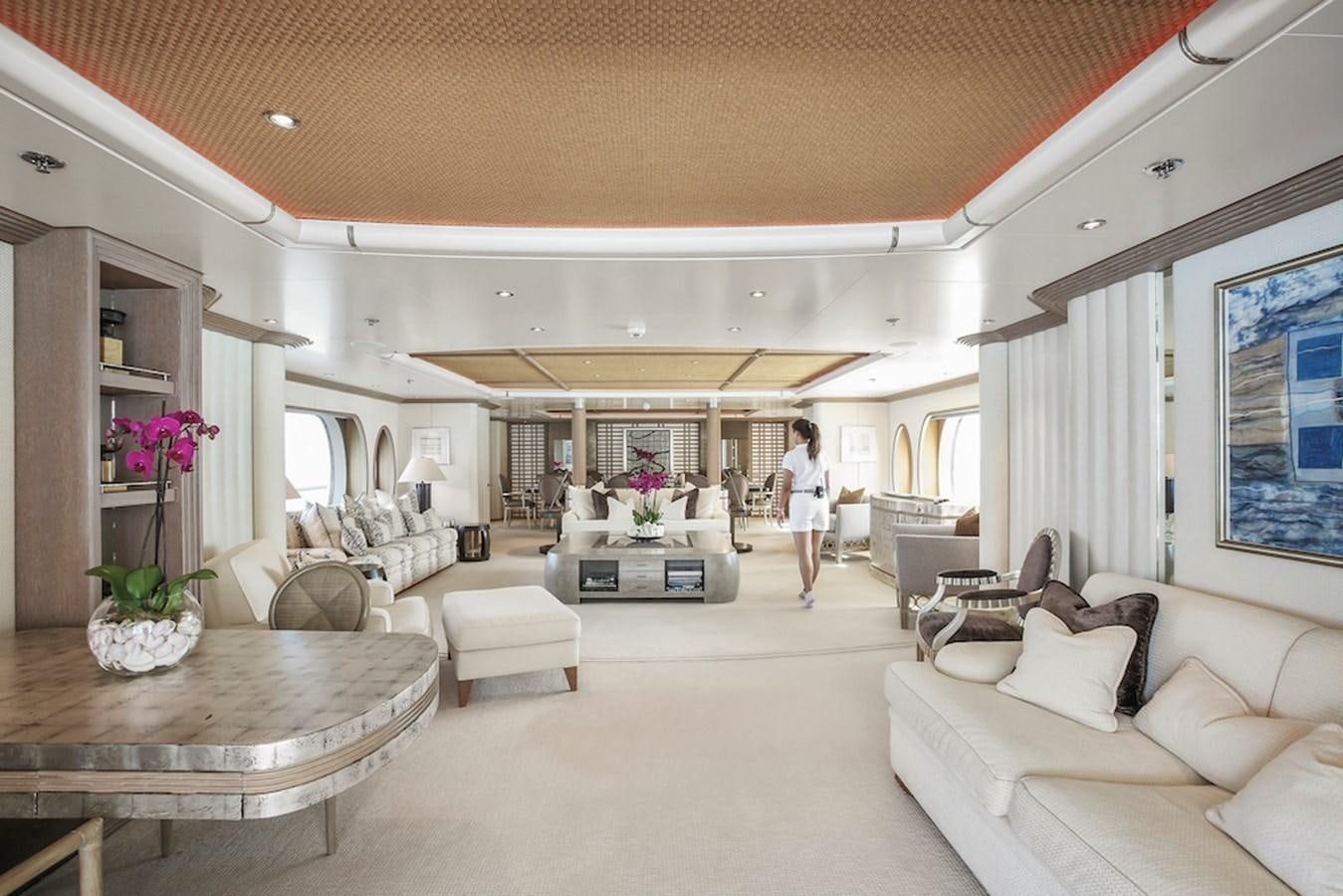 a person walking in a large living room aboard SAMIRA Yacht for Sale