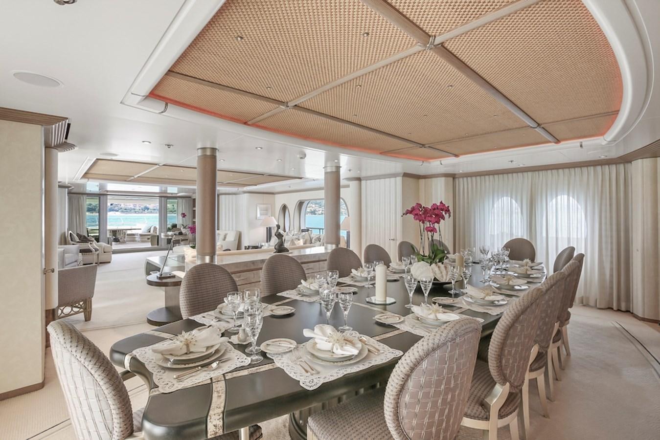 a large dining table with chairs and a large umbrella aboard SAMIRA Yacht for Sale