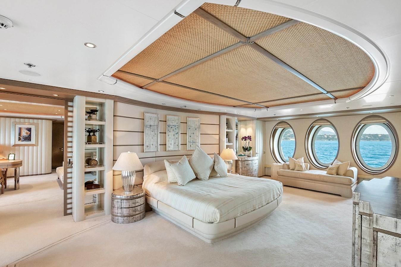 a large living room with a large white bed and a large window aboard SAMIRA Yacht for Sale