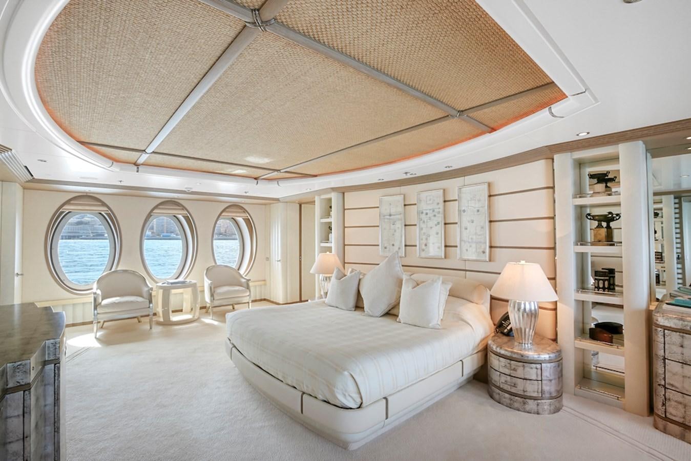 a large white room with a large white bed and a large white shelf aboard SAMIRA Yacht for Sale