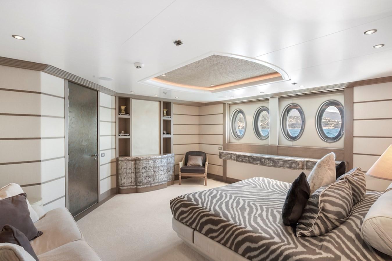 a large modern bedroom with a large open door aboard SAMIRA Yacht for Sale