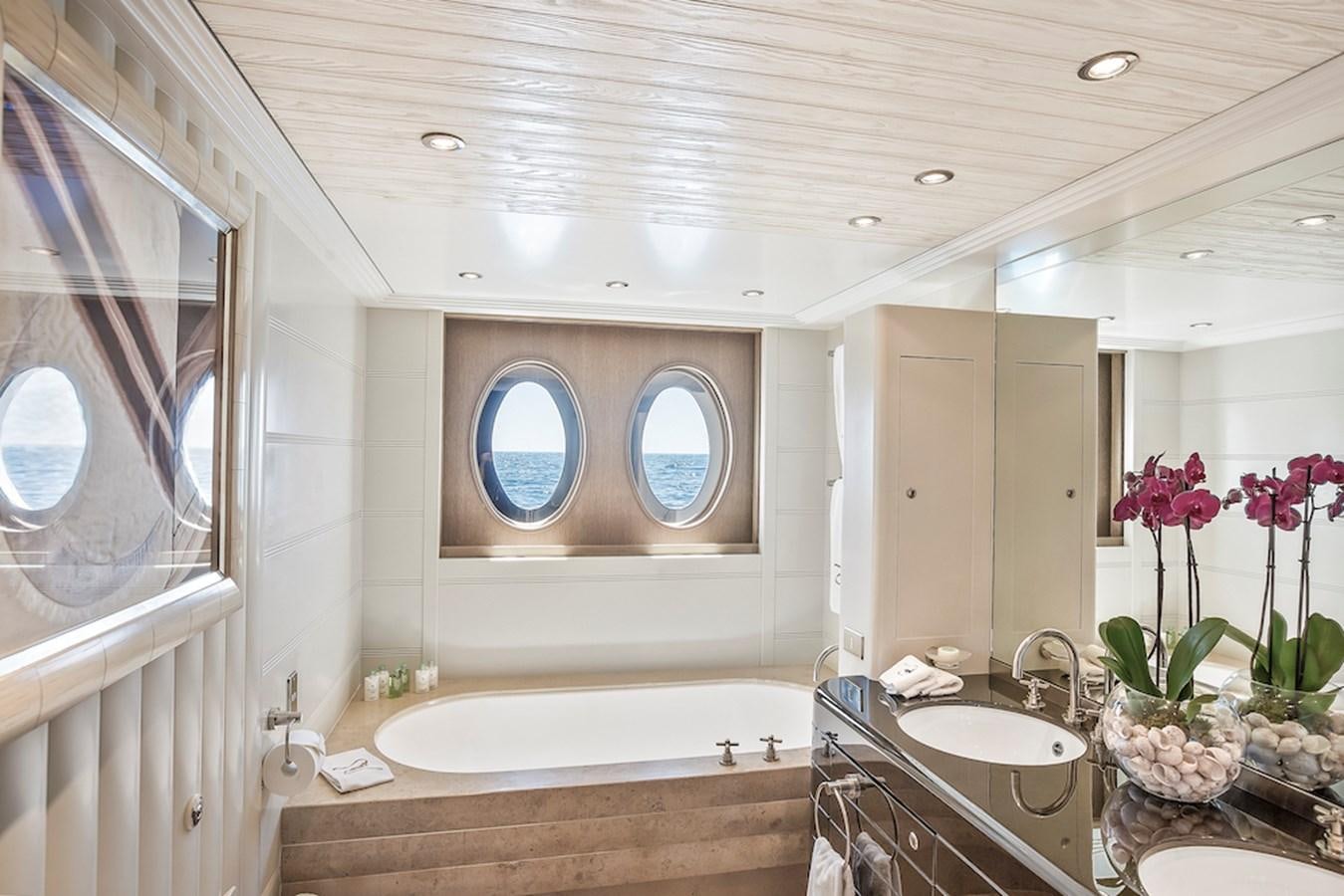 a bathroom with a tub sink and a sink aboard SAMIRA Yacht for Sale