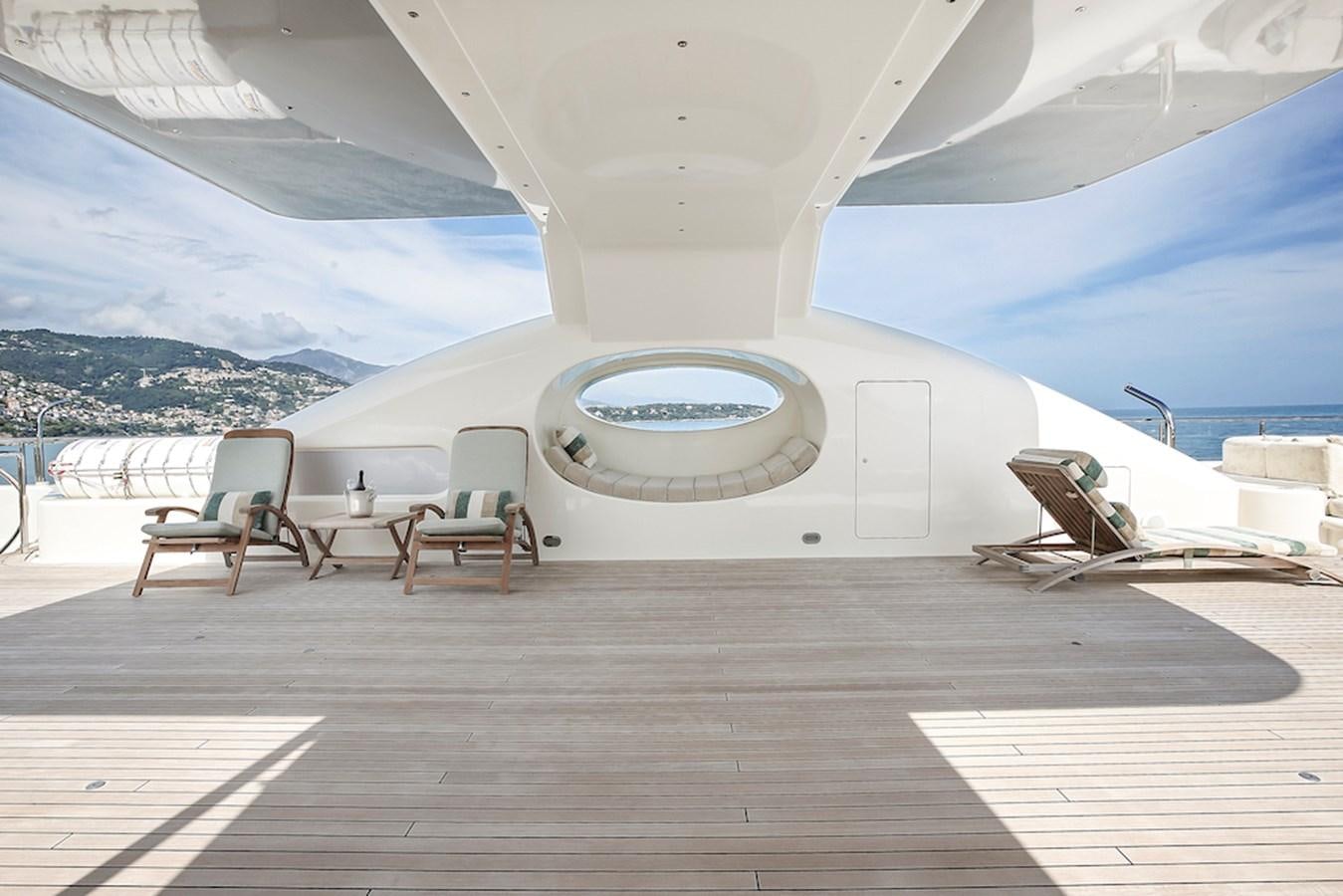 a large white tent with chairs and a table and a view of the water aboard SAMIRA Yacht for Sale