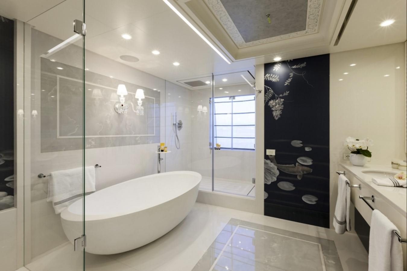 a bathroom with a tub and shower aboard QUINTA ESSENTIA Yacht for Sale