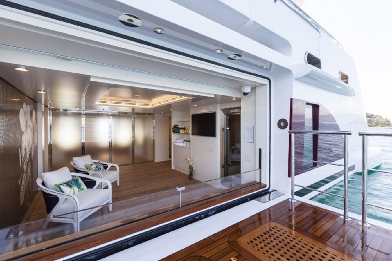 a room with a bed and a balcony aboard QUINTA ESSENTIA Yacht for Sale