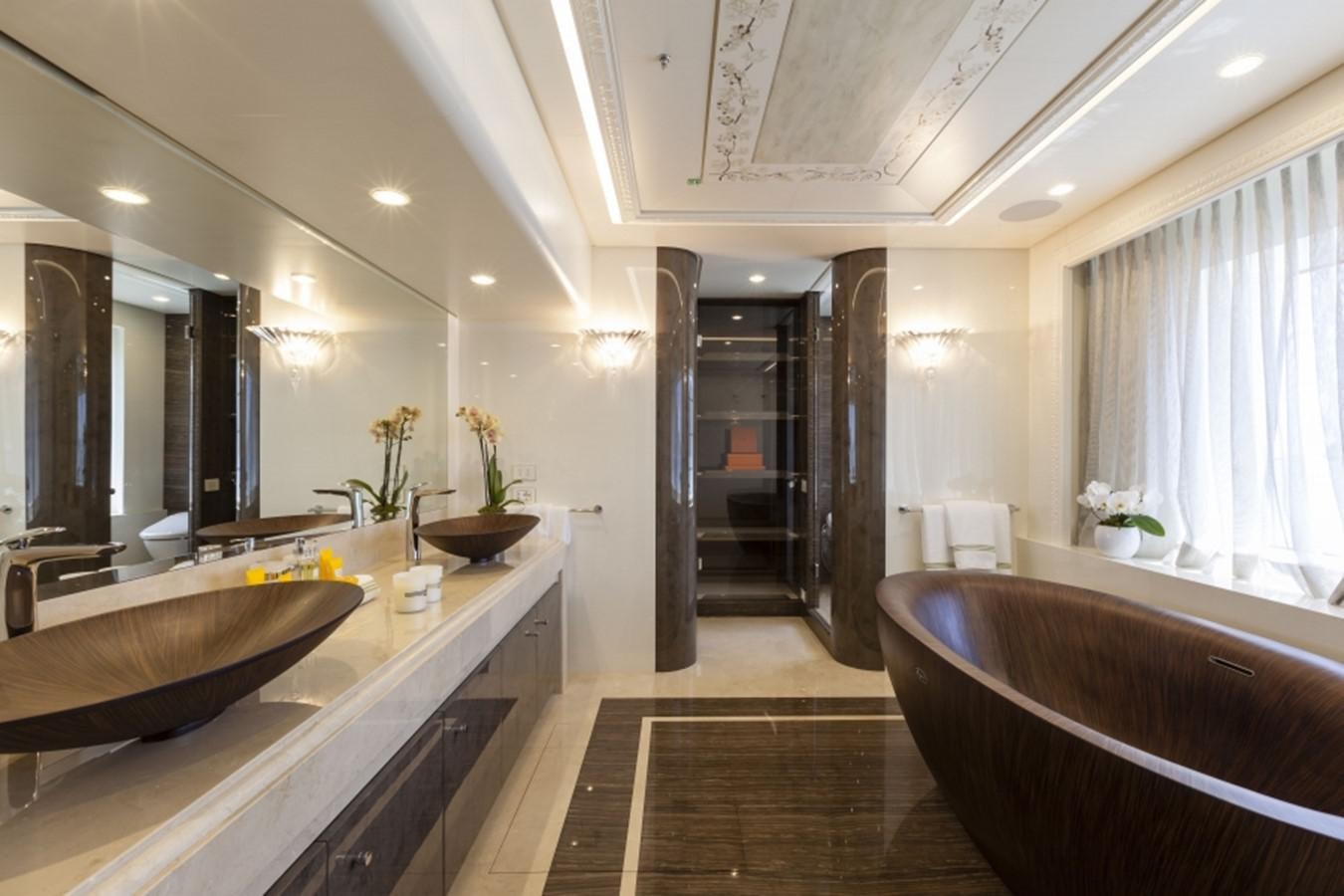 a bathroom with a tub sink and a large mirror aboard QUINTA ESSENTIA Yacht for Sale