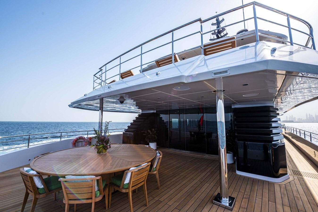 a deck with a table and chairs on it aboard MAJESTY 175 Yacht for Sale
