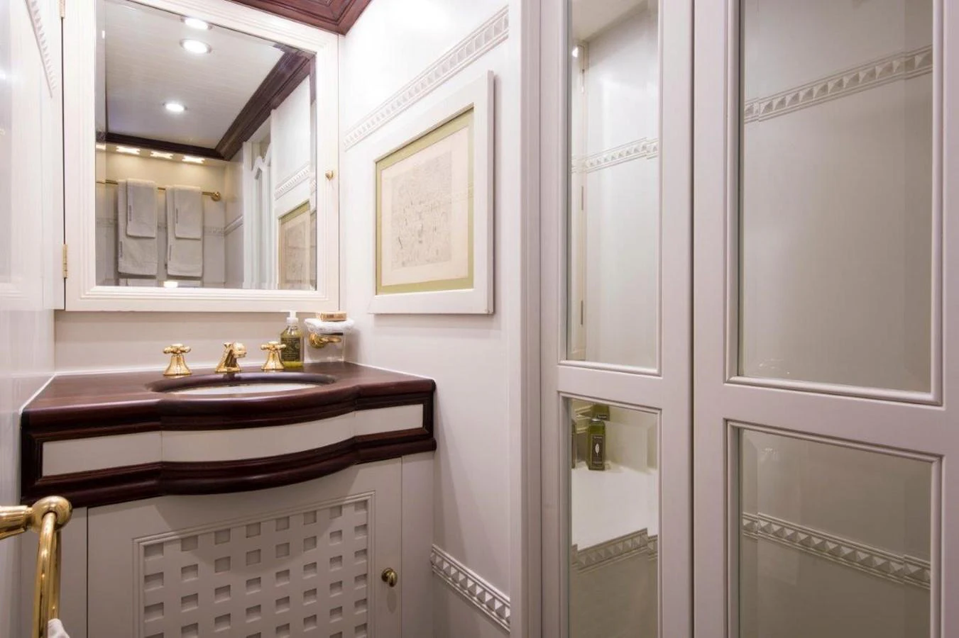 a bathroom with a sink and mirror aboard SHENANDOAH OF SARK Yacht for Charter