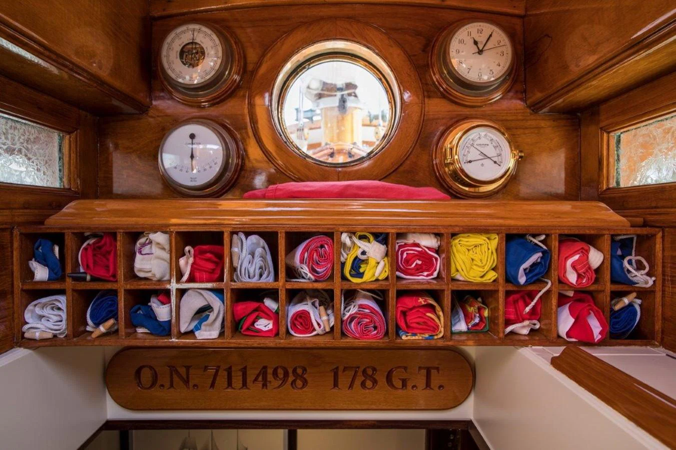 a clock and other clocks on a wall aboard SHENANDOAH OF SARK Yacht for Charter