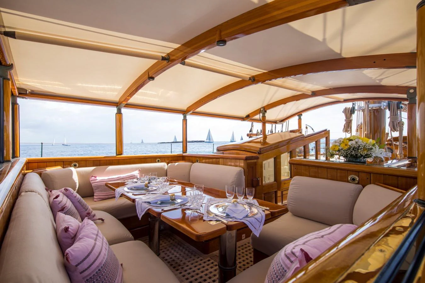 a large living room with a large window aboard SHENANDOAH OF SARK Yacht for Charter