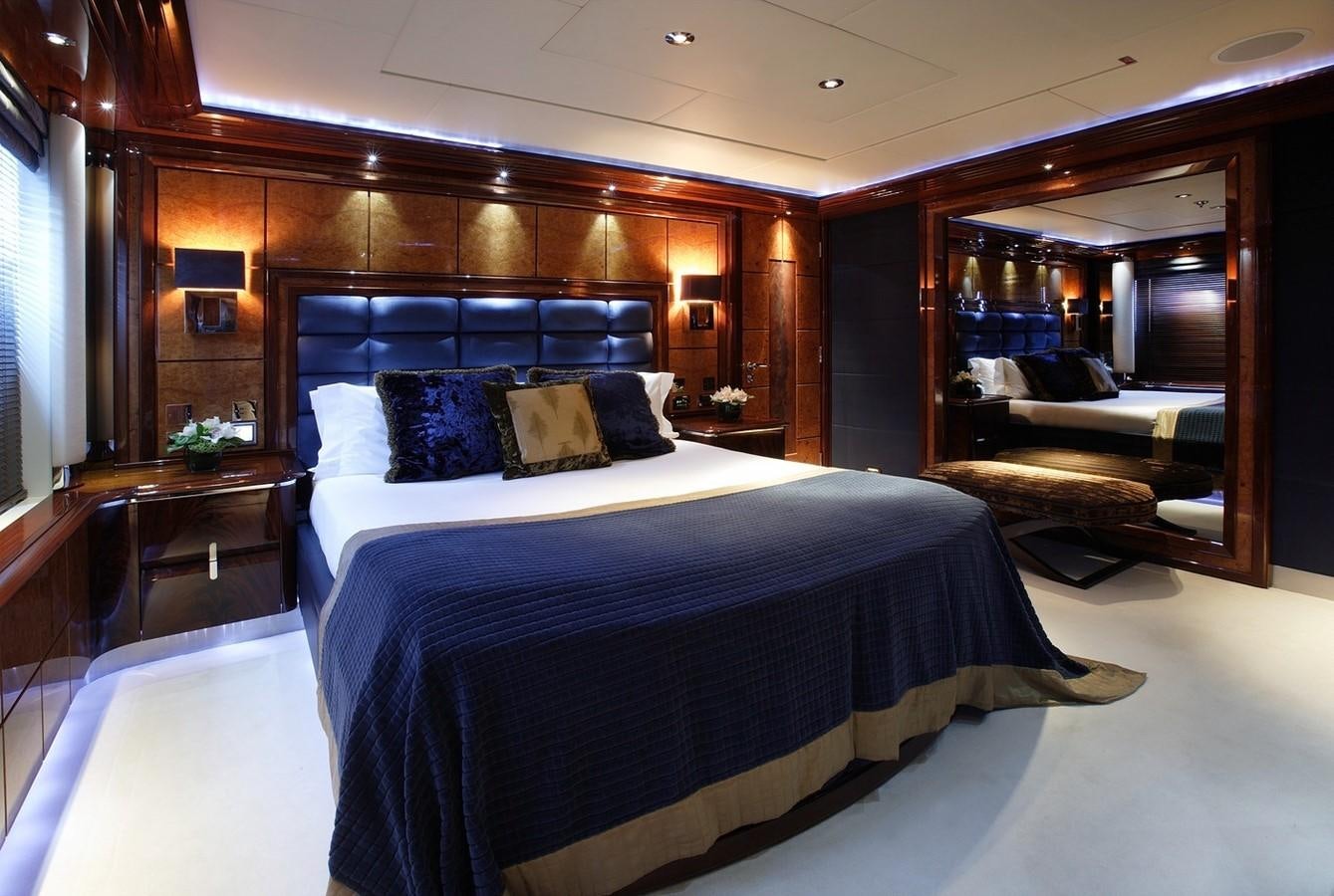 a large bedroom with a large mirror aboard TALISMAN MAITON Yacht for Sale
