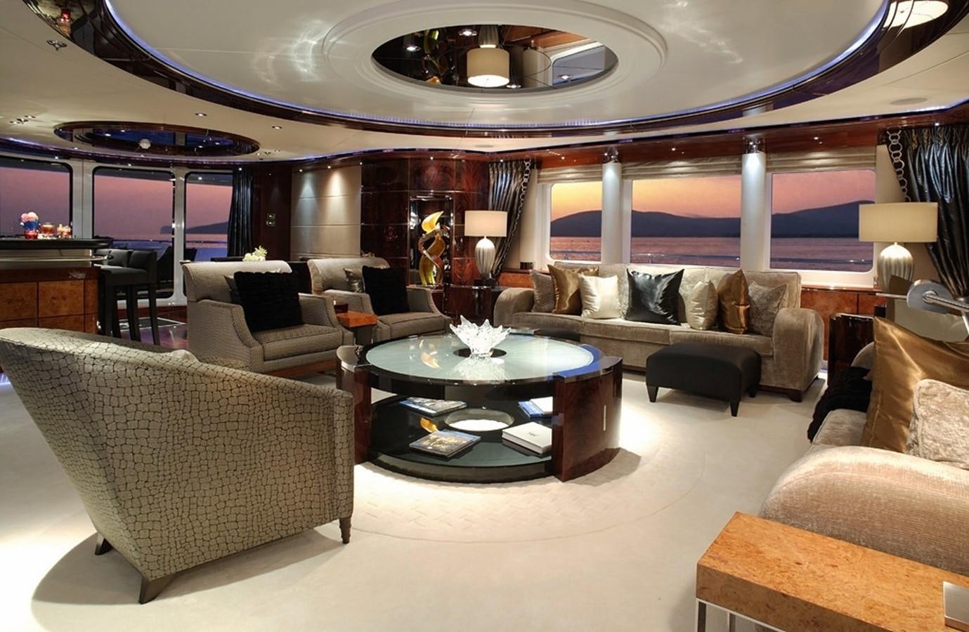 a large living room with a large chandelier aboard TALISMAN MAITON Yacht for Charter