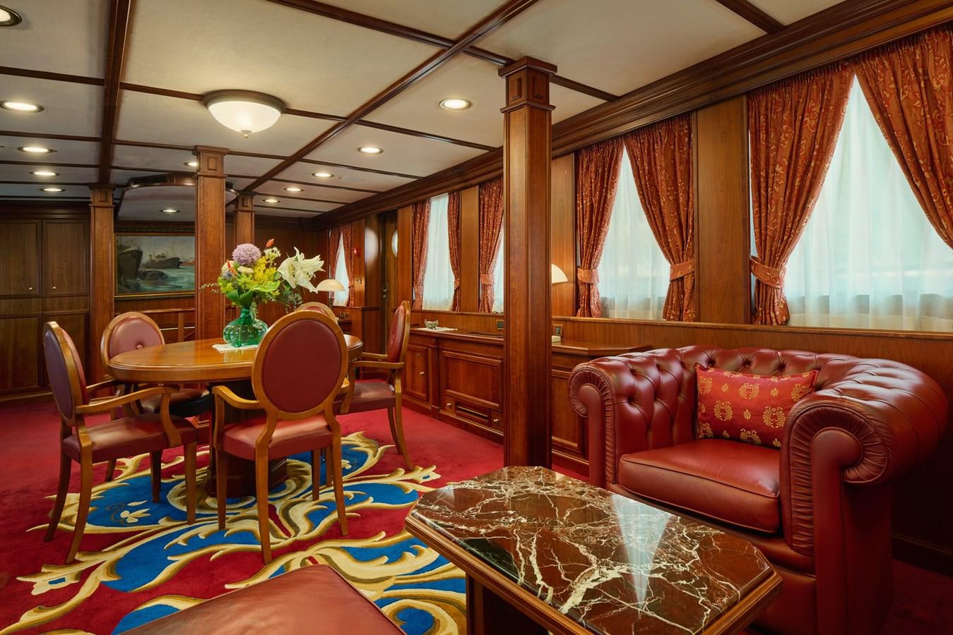 a living room with a table and chairs aboard SEAGULL II Yacht for Sale