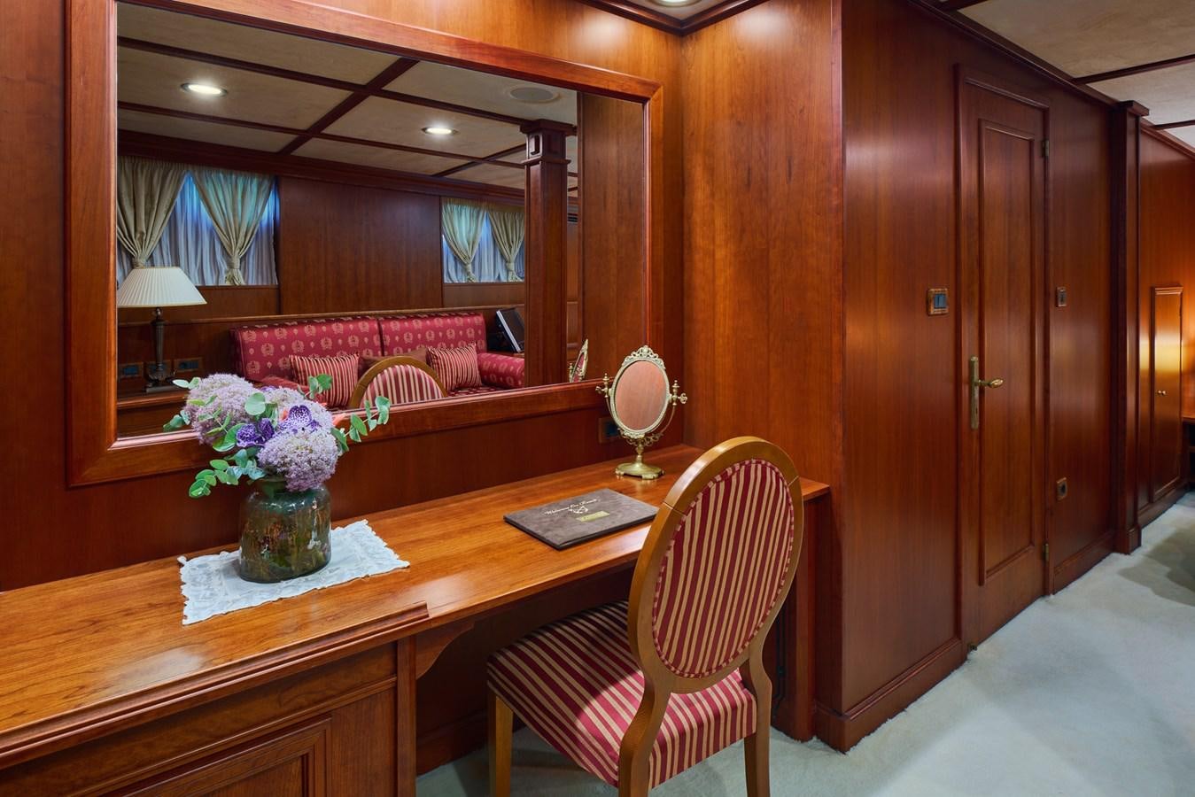a table with a chair and a vase of flowers on it aboard SEAGULL II Yacht for Sale