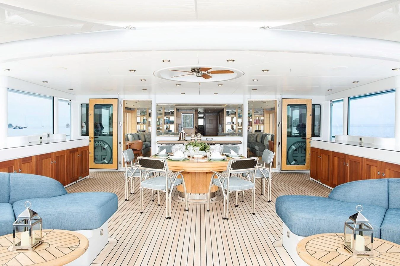 a living room with a table and chairs aboard FORTUNATE SUN Yacht for Sale